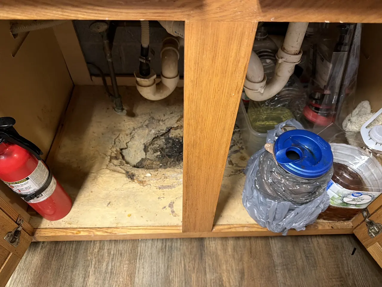 Sink base cabinet floor deteriorated by a long-term plumbing leak